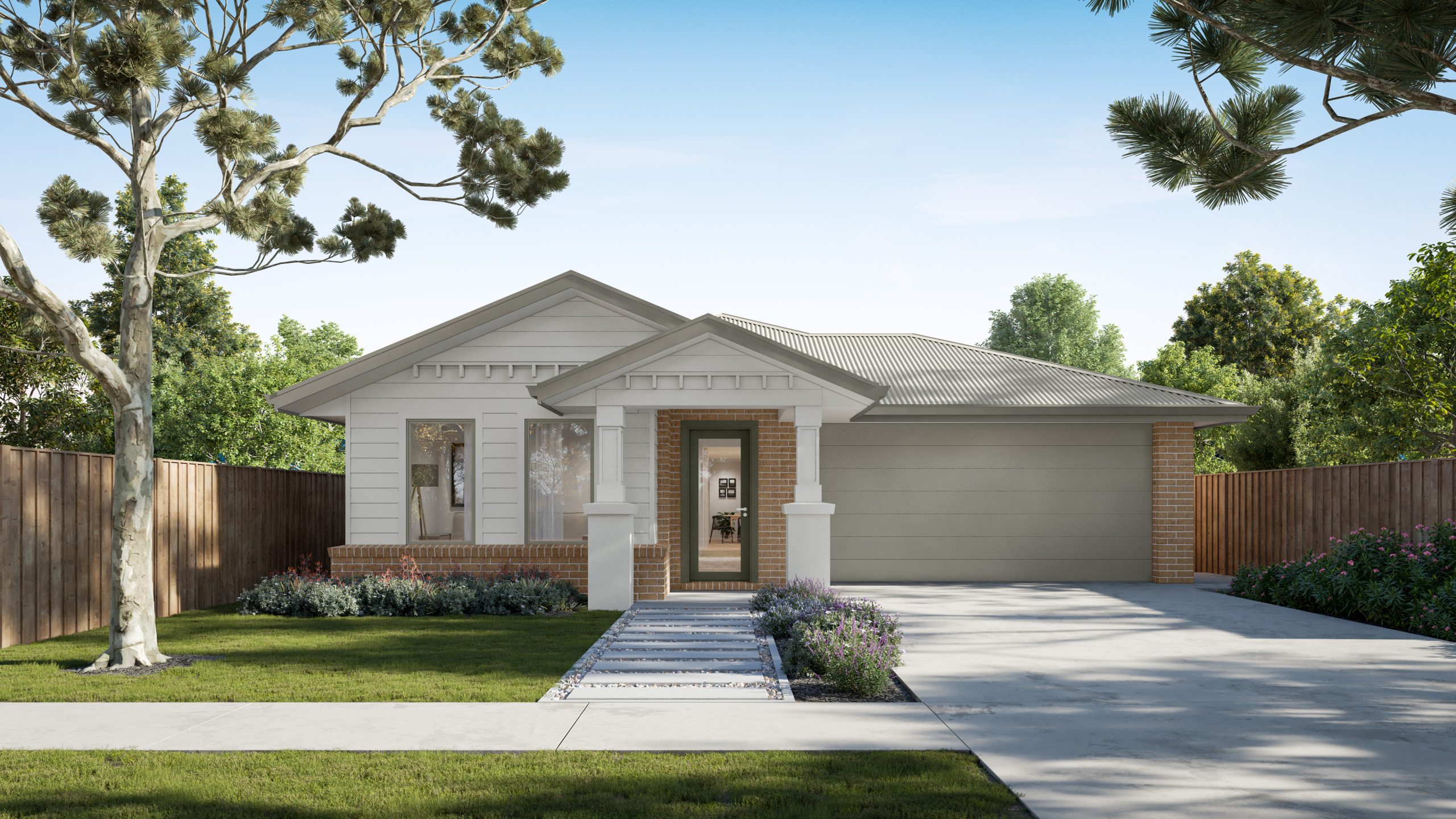 Single-storey contemporary home with a light weatherboard and brick façade, pitched roof, and double garage. A landscaped front yard features a green lawn, flowering garden beds, a paved path leading to the front entrance, and mature trees framing the property on a sunny day.