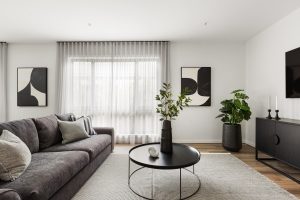 new home with couch and sheer curtains