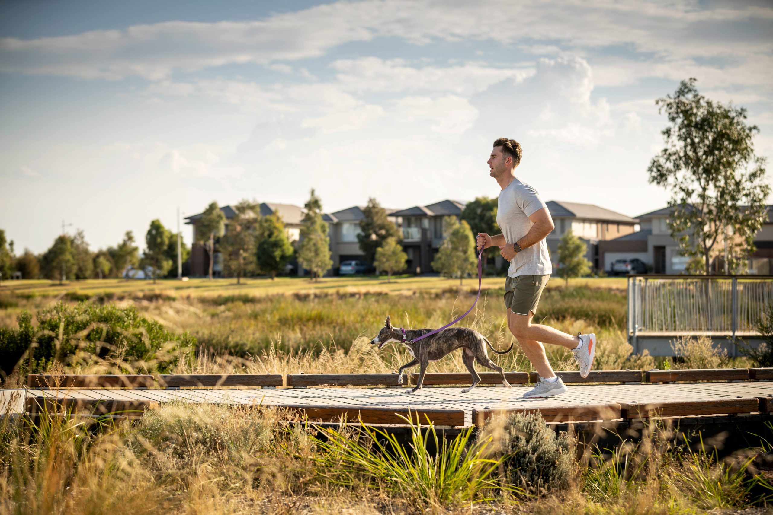 man running with dog