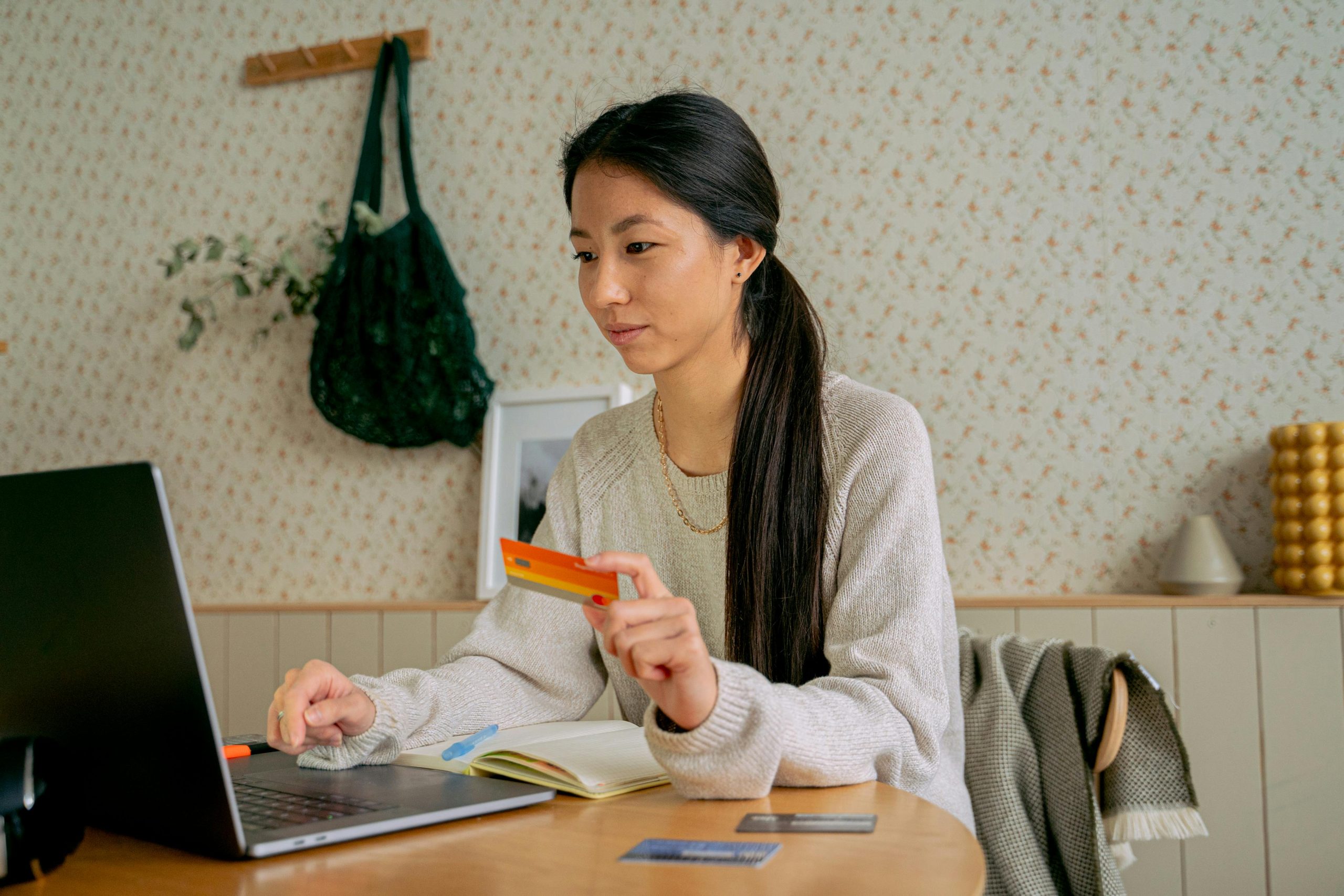 woman on laptop holding credit card