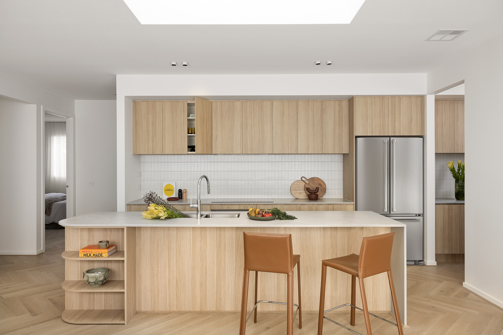 Modern Mayde Homes kitchen with island bench and open-plan living space